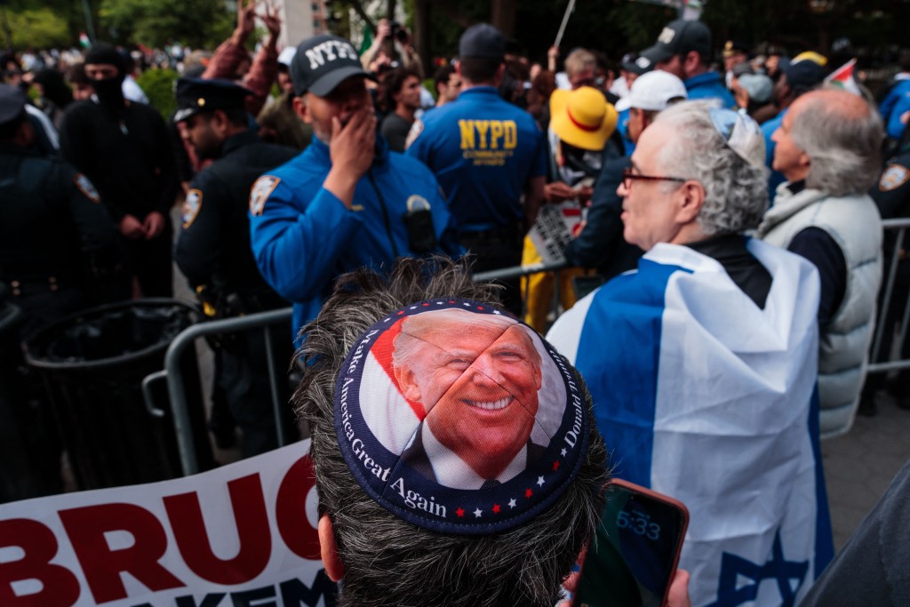 A pro-Israel counter protestor wears a yarmulke with an image of U.S. President Donald Trump as pro-Palestinian activists take part in a protest on Nakba Day on May 15, 2026 in New York City. Pro-Palestinian activists worldwide marked the 78th anniversary of the Nakba amid the ongoing Israel-Gaza conflict. Adam Gray/Getty Images/AFP