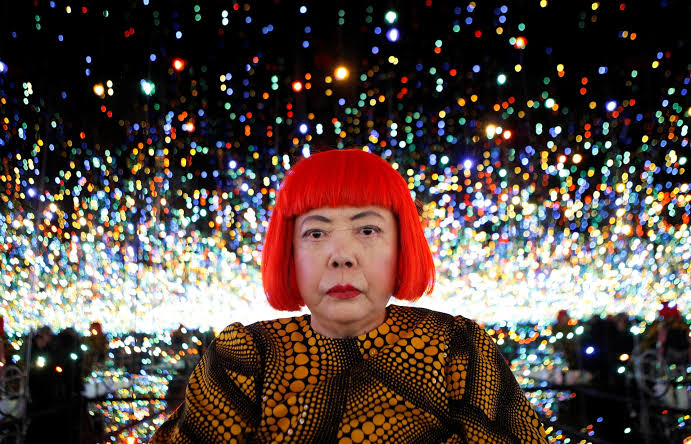 Japanese artist Yayoi Kusama poses for a photograph inside her Infinity Mirrored Room installation titled "The Souls of Millions of Light Years Away" during a media preview of her new exhibition at the David Zwirner gallery in New York November 7, 2013. REUTERS/Mike Segar/File