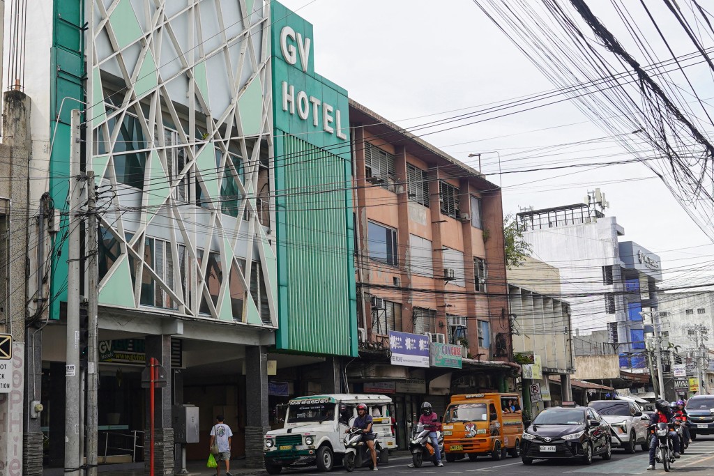 Photo by FERDINANDH CABRERA / AFP  The facade of GV hotel is seen in Davao City, in the Philippines' southern island of Mindanao, where father-and-son duo Sajid and Naveed Akram stayed during their visit in November, weeks before they allegedly killed 15 people on Bondi Beach in Australia.