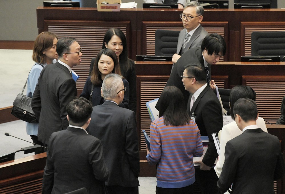 Paul Lam, left, and Chris Tang talk to their staff after the joint panel meeting. SING TAO Paul Lam, left, and Chris Tang talk to their staff after the joint panel meeting. SING TAO