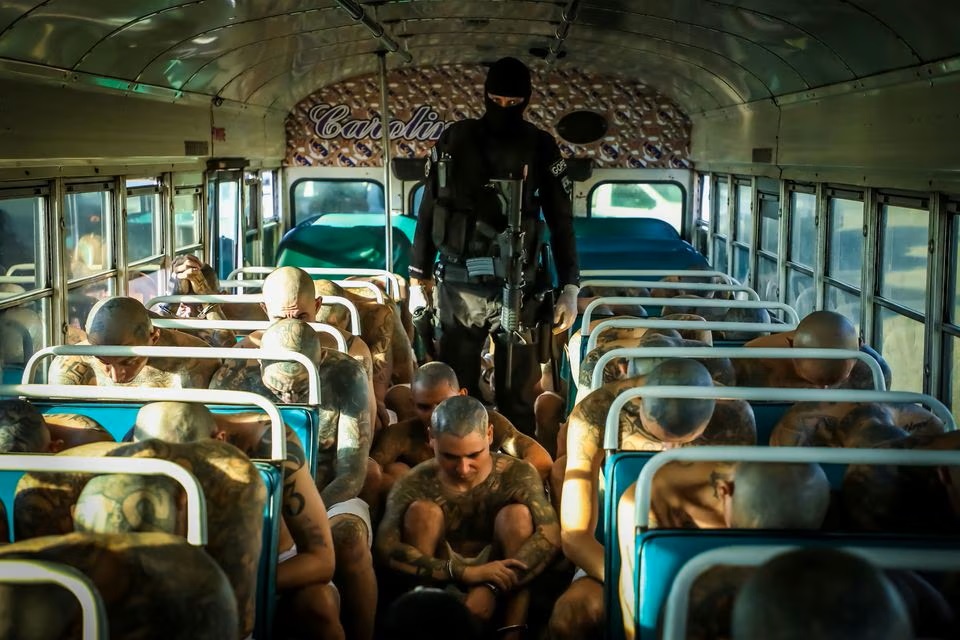 A prison agent guards gang members as they are transported to their cells, after 2000 gang members were transferred to the Terrorism Confinement Center, according to El Salvador's President Nayib Bukele, in Tecoluca, El Salvador. (Reuters) A prison agent guards gang members as they are transported to their cells, after 2000 gang members were transferred to the Terrorism Confinement Center, according to El Salvador's President Nayib Bukele, in Tecoluca, El Salvador. (Reuters)