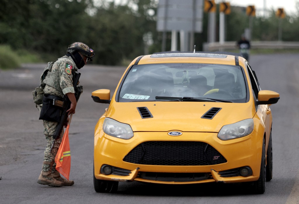 A member of the Mexican Army stops a vehicle at a checkpoint near the site where "R1", a leader of the Jalisco New Generation Cartel (CJNG), was captured in Atotonilco el Alto, Jalisco state, Mexico, on July 30, 2026. Mexico said on July 30 it had captured the alleged mastermind behind the assassination of a hardline anti-crime mayor last November, a killing that sparked international outrage.