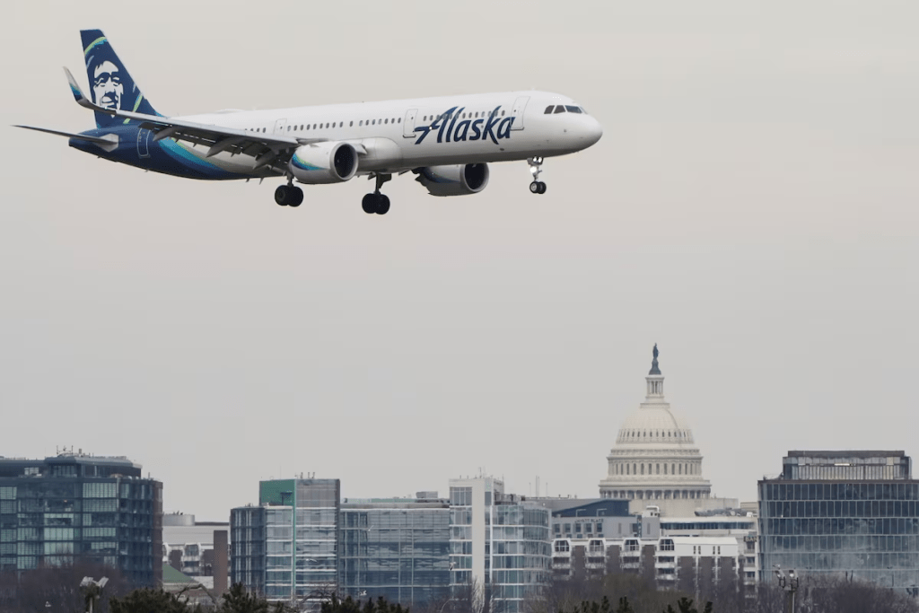 An Alaska Airlines aircraft flies past the U.S. Capitol before landing at Reagan National Airport in Arlington, Virginia, U.S., January 24, 2022. REUTERS/Joshua Roberts