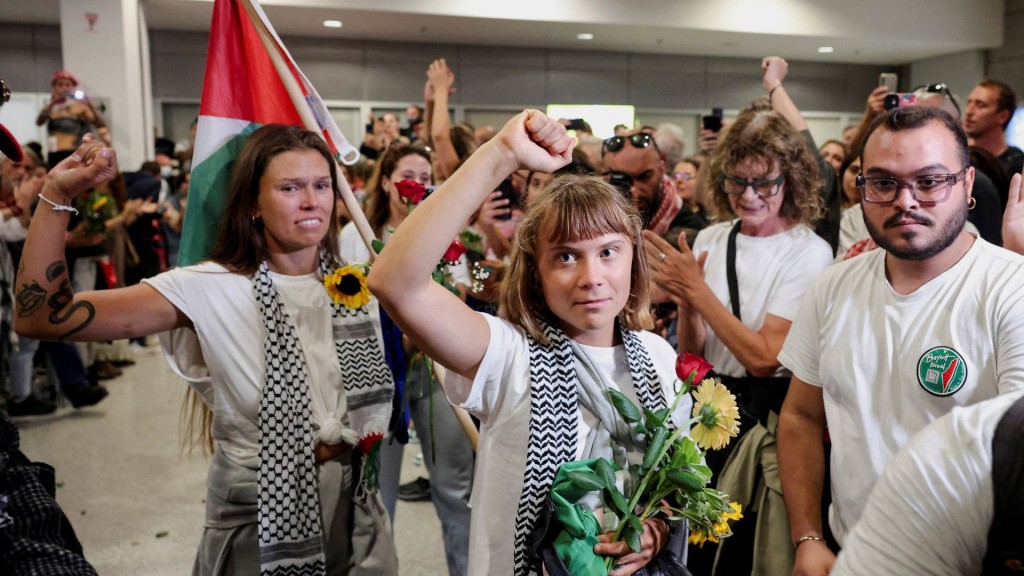 Swedish activist Greta Thunberg gestures upon her arrival to the Athens Airport. Reuters