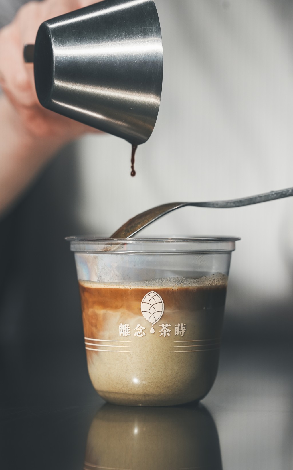 The “Floating Dir-Tea,” a layered drink that combines espresso with chilled tea-infused oat milk.