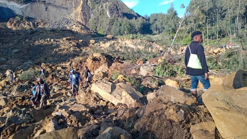 People gather at the site of a massive landslide in Papua New Guinea's Enga province on Friday © STR / AFP People gather at the site of a massive landslide in Papua New Guinea's Enga province on Friday © STR / AFP