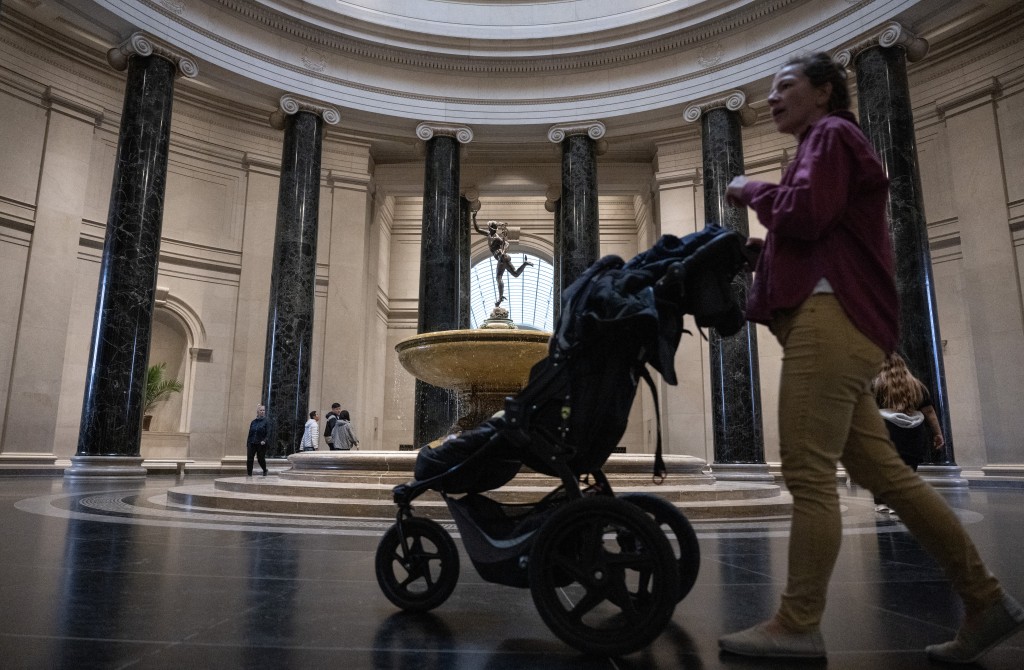 Photo by ANDREW CABALLERO-REYNOLDS / AFP  A woman walks through the National Art gallery on the first day of the Smithson museum openings after the US Government reopened on the National Mall in Washington, DC on November 14, 2025.