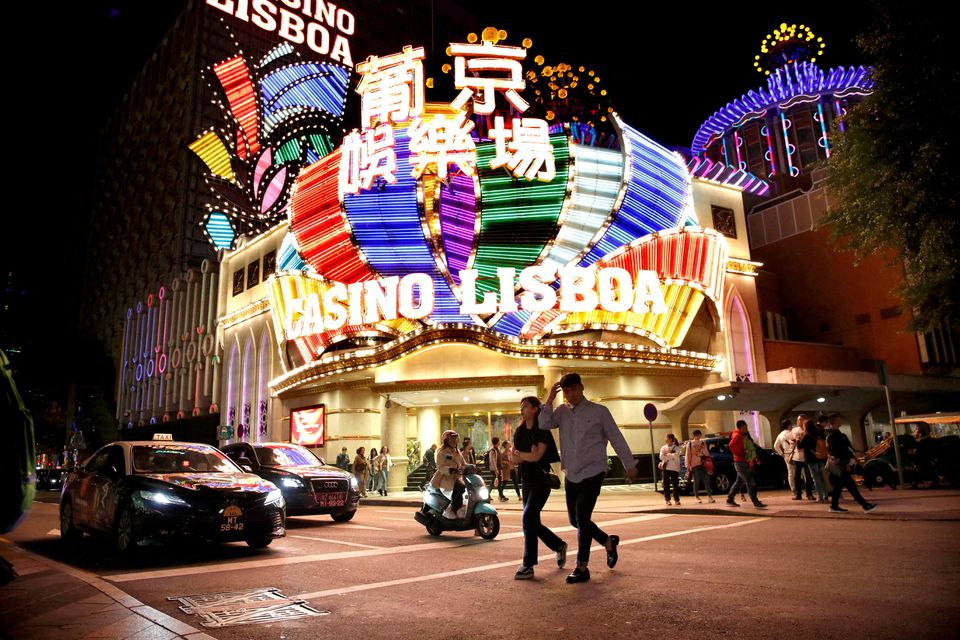 People walk past Casino Lisboa in Macau. (Reuters) People walk past Casino Lisboa in Macau. (Reuters)