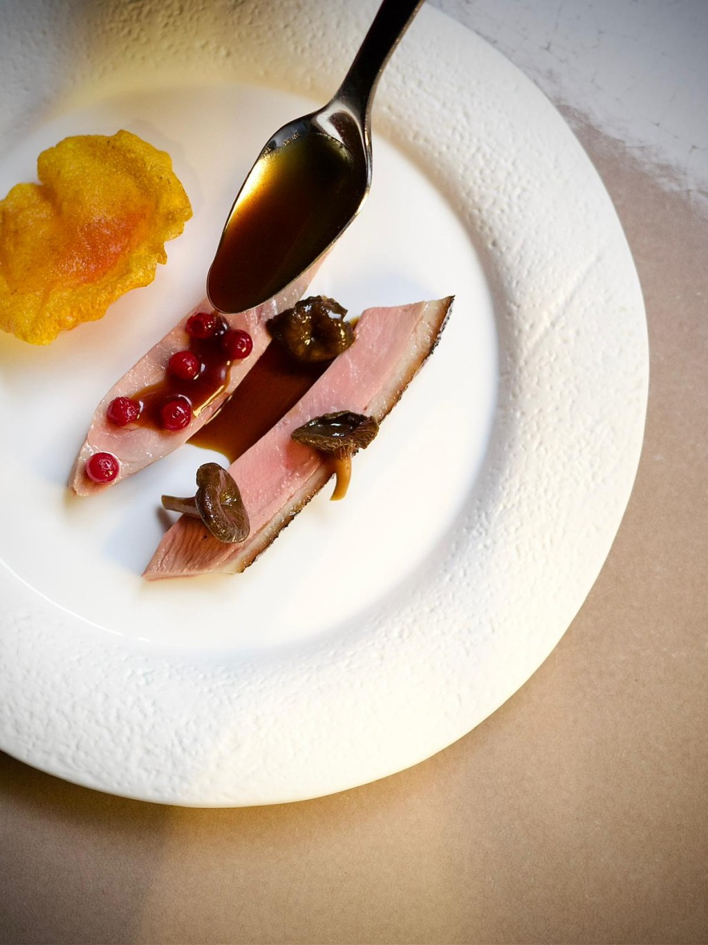 Ami's signature dish Barbarie duck, butternut mousseline and crisp, chanterelle, cranberry jus