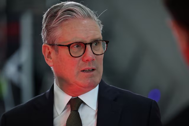 Britain's Prime Minister Keir Starmer speaks with staff members during a visit to a defence contractor in Bedfordshire, Britain, May 2, 2025. HENRY NICHOLLS/Pool via REUTERS