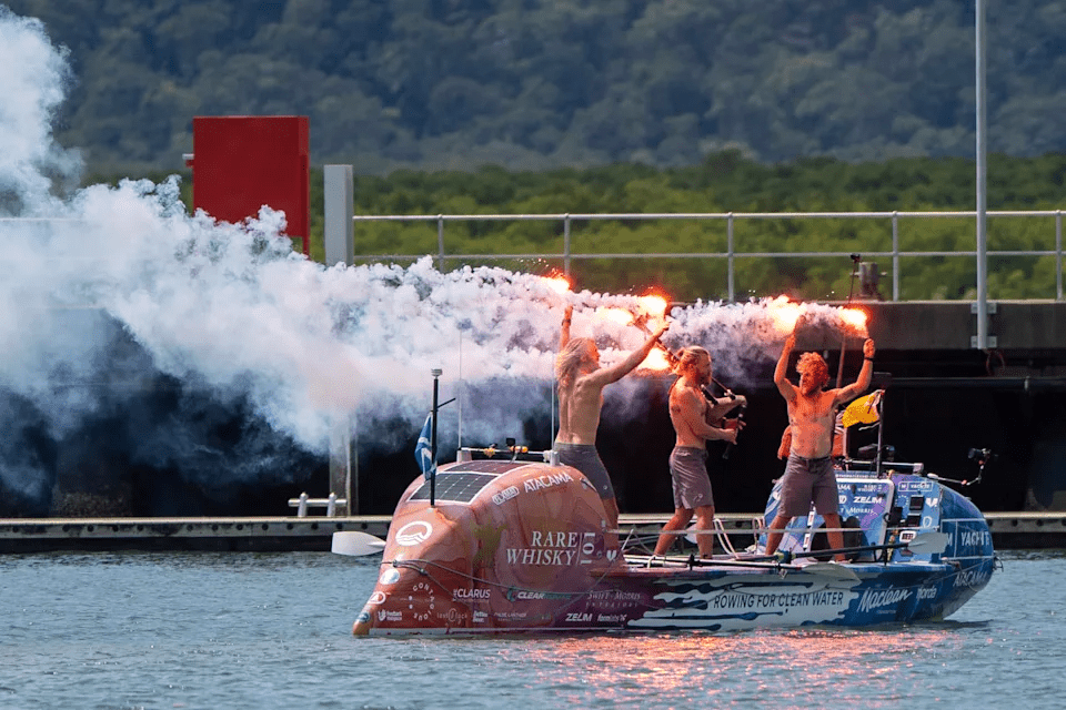 Scottish brothers, Ewan, Jamie and Lachlan, Maclean react after completing their record breaking row from Peru across the Pacific Ocean to Cairns, Australia, Saturday, Aug. 30, 2025. (Nuno Avendano/AAP Image via AP)
