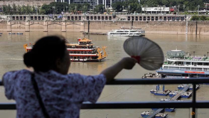 A person looks at boats on Yangtze River in Chongqing, China, on Jun 11, 2025. (File photo: REUTERS/Go Nakamura)