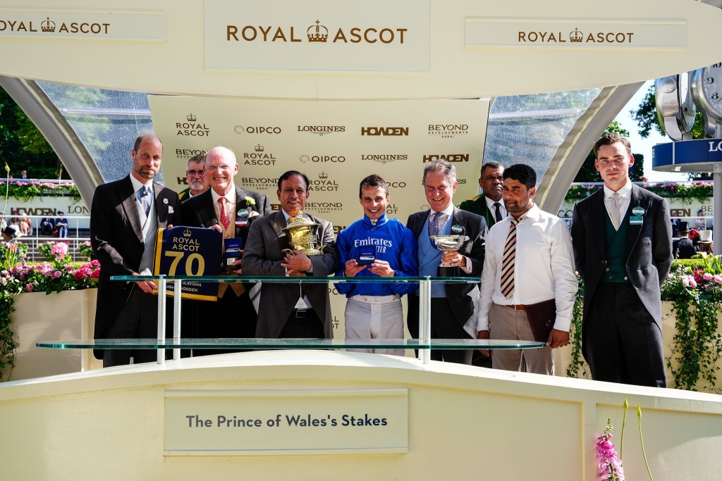 The Prince of Wales presents John Gosden with a commemorative saddlecloth after reaching 70 Royal Ascot wins following Ombudsman's win in the G1 Prince of Wales's Stakes (ASCOT) 
