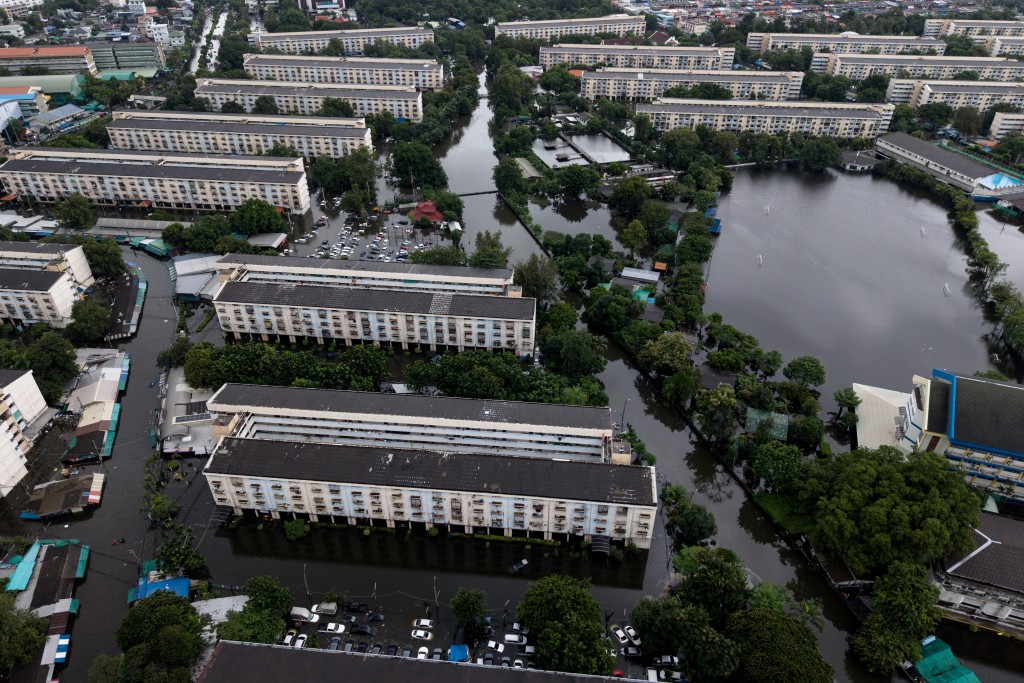 An aerial view shows floodwater surrounding apartment complexes at Bang Kapi district in Bangkok on September 27, 2026. (AFP)
