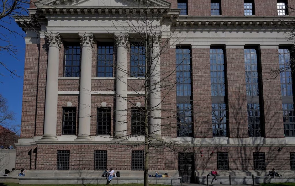 Students sit at the campus of Harvard University in Cambridge, Massachusetts, U.S., April 15, 2025. REUTERS/Faith Ninivaggi/File Photo