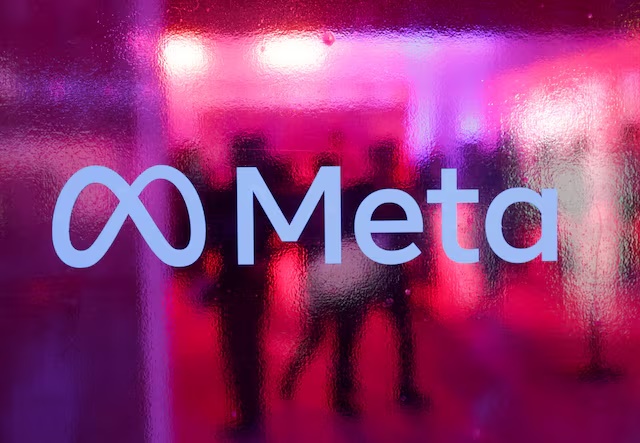 People walk behind a logo of Meta Platforms company, during a conference in Mumbai, India, September 20, 2023. REUTERS/Francis Mascarenhas 