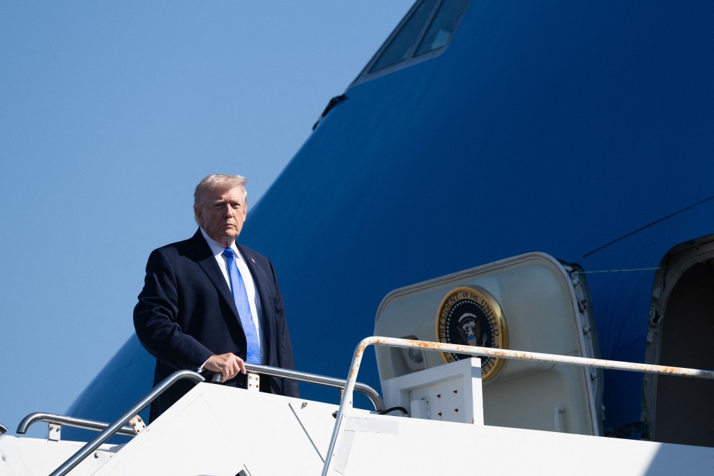 Photo by SAUL LOEB / AFP  US President Donald Trump boards Air Force One prior to departure from Palm Beach International Airport in West Palm Beach, Florida, March 23, 2026.