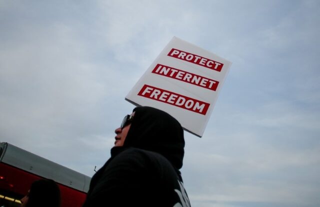FILE PHOTO: A supporter of Net Neutrality, Lance Brown Eyes, protests the FCC's recent decision to repeal the program in Los Angeles, California, November 28, 2017. REUTERS/ Kyle Grillot 