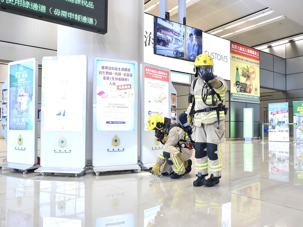 FSD officers detecting hazardous material with a portable multi-gas detector during the drill.
