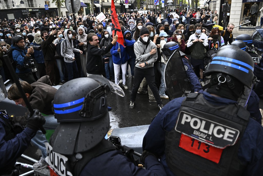 Protesters clash with French BRAV-L police in riot gear next to French journalist Remy Buisine during a demonstration in solidarity with high-school students near Sciences Politiques (Paris Institute of Political Studies) university as part of a nationwide protest movement over learning conditions in Paris, on October 7, 2026. (AFP)