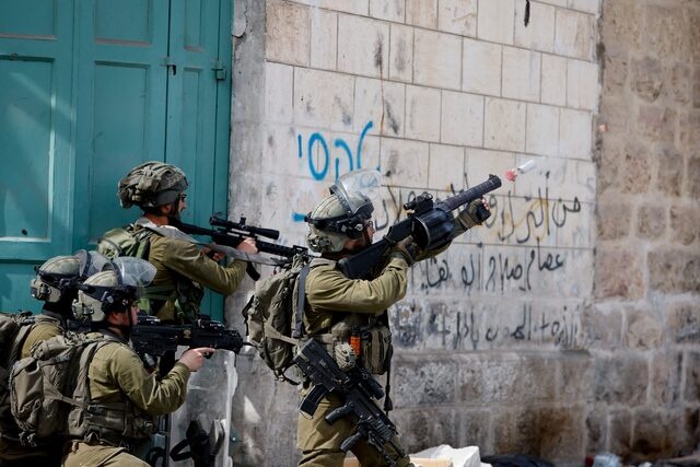 Representative photo - An Israeli soldier uses a weapon amid clashes with Palestinian protesters, in Hebron, in the Israeli- occupied West Bank April 1, 2022. REUTERS/Mussa Qawasma