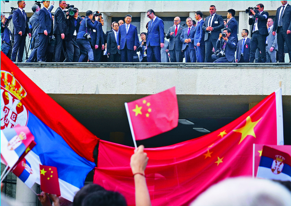 Xi Jinping, with Aleksandar Vucic, looks on from the balcony as he is greeted by a flag-waving crowd outside the main government offices in Belgrade. 'Such respect and love as he will find here in our Serbia, he will not find anywhere else,' Vucic sa Xi Jinping, with Aleksandar Vucic, looks on from the balcony as he is greeted by a flag-waving crowd outside the main government offices in Belgrade. 'Such respect and love as he will find here in our Serbia, he will not find anywhere else,' Vucic sa