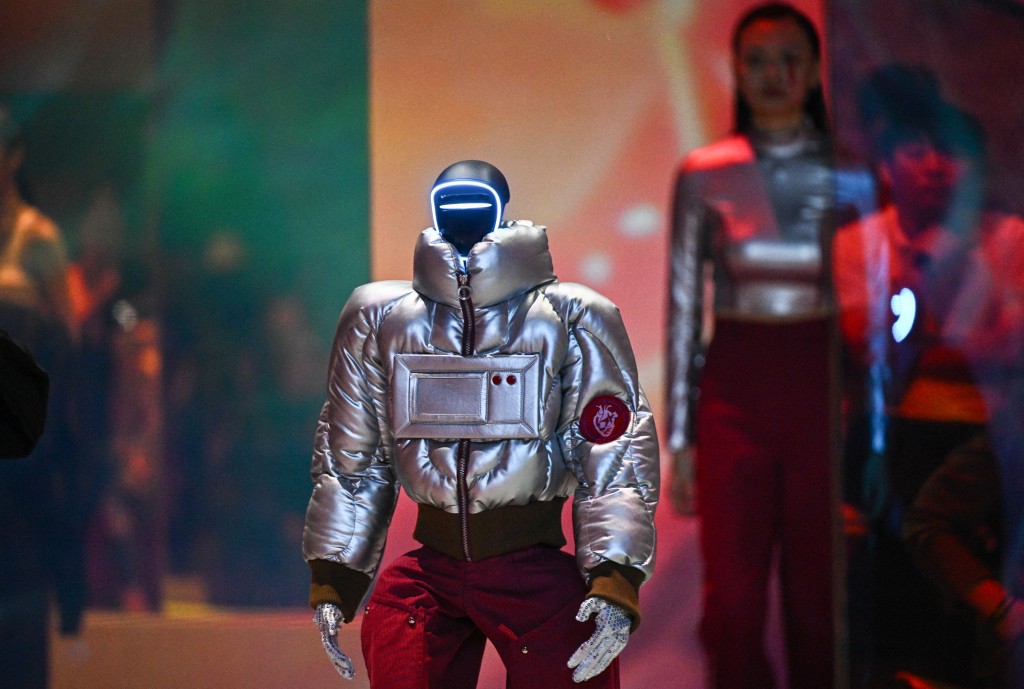 TOPSHOT - Humanoid robots and models perform as they present creations at Galaxy Corporation's "Mach33: Physical AI Fashion Show" in Seoul on May 28, 2026. (Photo by Pedro PARDO / AFP)