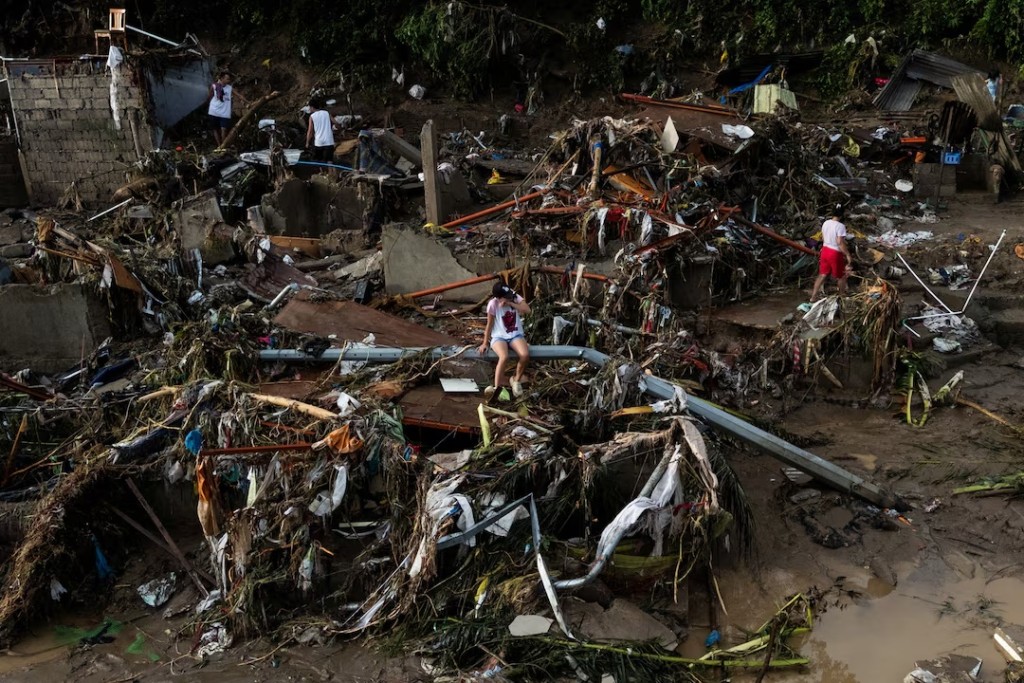 A drone view of a woman sitting on a fallen post amid the damage caused by Typhoon Kalmaegi in Talisay, Cebu, Philippines, November 5, 2025. REUTERS/Eloisa Lopez 