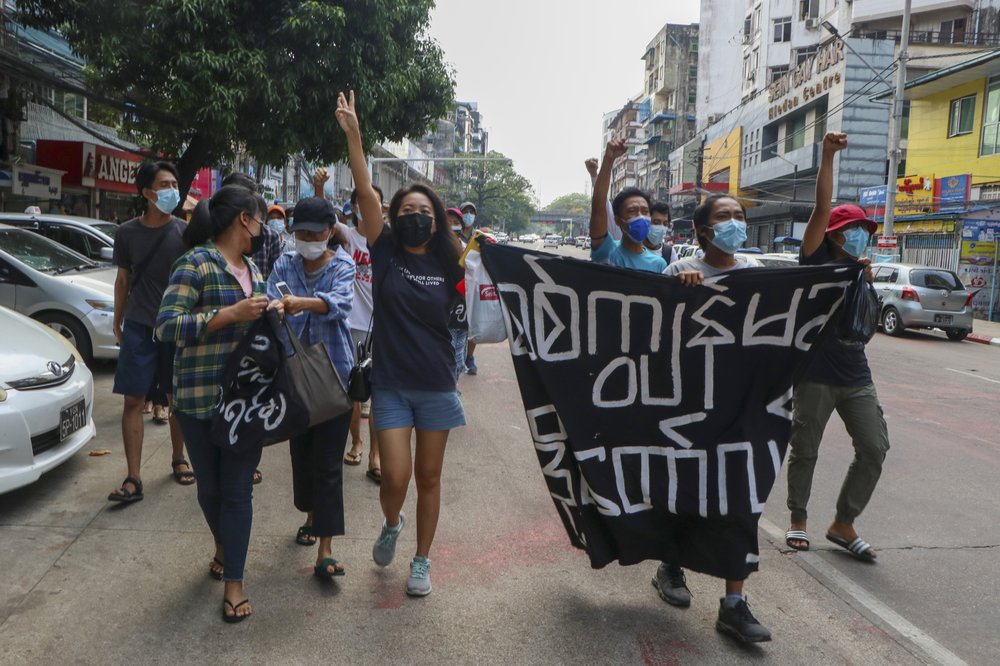 Anti-coup protesters shout slogan with a banner reading ''Carry on revolution! We do not accept as the military slave,'' in Kamayut township of Yangon, Myanmar, Monday, April 19, 2021. Anti-coup protesters kept public demonstrations going despite the threat of lethal violence from security forces. Anti-coup protesters shout slogan with a banner reading ''Carry on revolution! We do not accept as the military slave,'' in Kamayut township of Yangon, Myanmar, Monday, April 19, 2021. Anti-coup protesters kept public demonstrations going despite the threat of lethal violence from security forces.