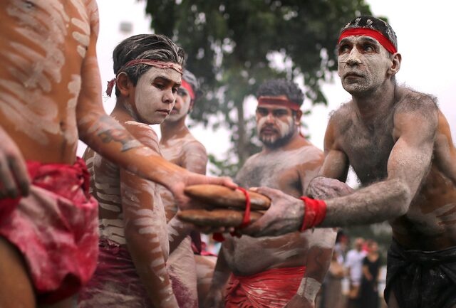 Members of Koomurri Aboriginal Dance Troupe participate in a traditional Australian Aboriginal smoking ceremony as part of celebrations for Australia Day, which marks the arrival of Britain's First Fleet in 1788, in central Sydney, Australia, January 26, 2018. REUTERS/Steven Saphore