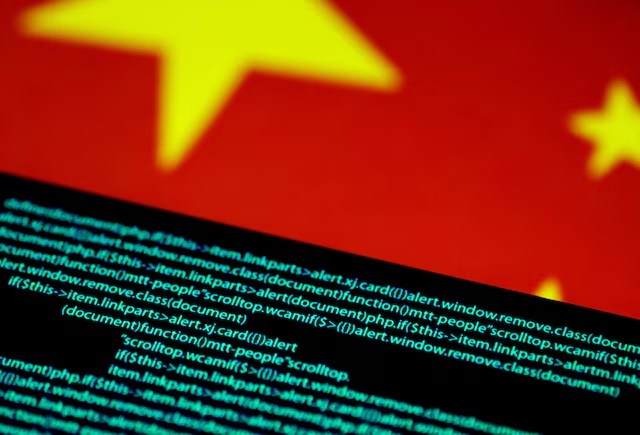 Computer code is seen on a screen above a Chinese flag in this July 12, 2017 illustration photo. REUTERS/Thomas White/Illustration/File Photo 