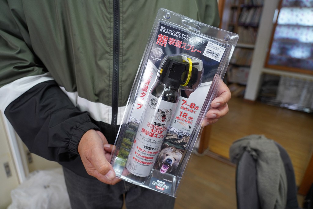 Photo by CAROLINE GARDIN / AFP  Takuya Terabashi, director of the Sasama Nursery School, holds a can of bear spray at the nursery in Hanamaki, Iwate prefecture on October 24, 2025.