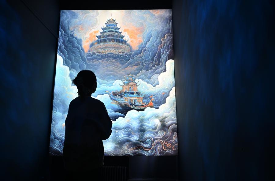 A visitor views a painting at an exhibition themed on Dunhuang culture at the Tianjin Digital Art Museum in Tianjin, north China, Nov. 28, 2023.  (Xinhua)
