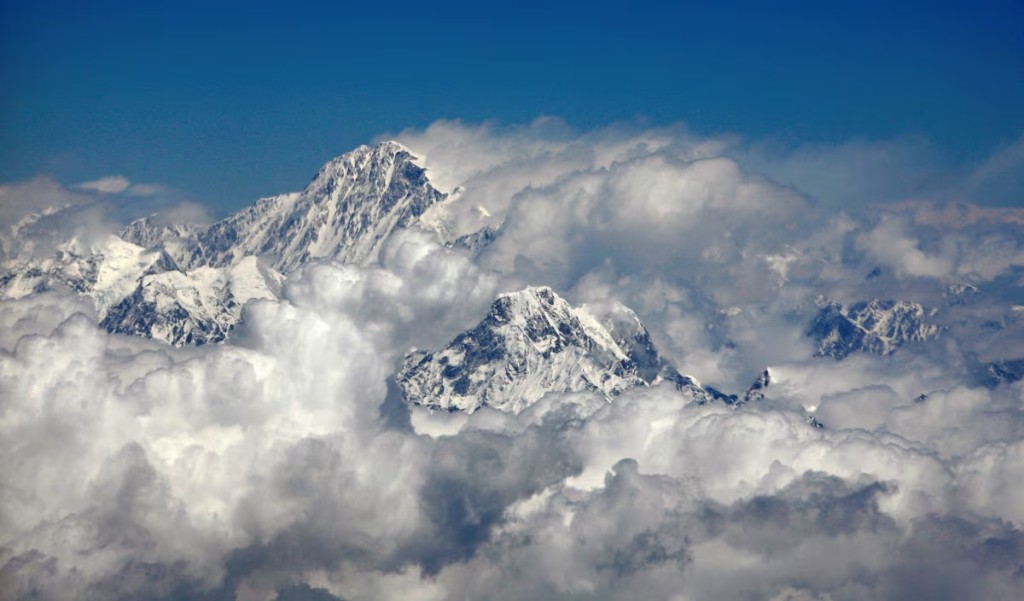 Mount Everest or Sagarmatha (top), highest peak in the world with an altitude of 8.848 metres (29.028 ft) is seen in this aerial view next to 6.812 metres (22.349 feet) high Mount Ama Dablam (bottom R) April 22, 2007. REUTERS/ Desmond Boylan/File Photo
