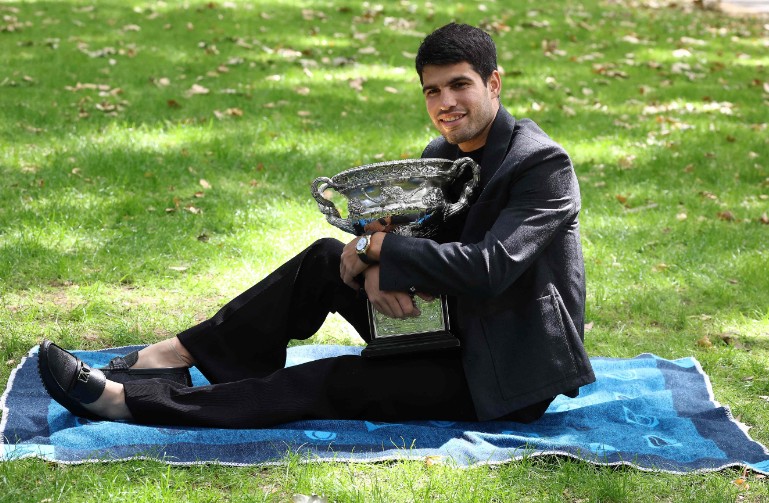 Carlos Alcaraz poses with the trophy the day after his victory over Novak  Djokovic. AFP 