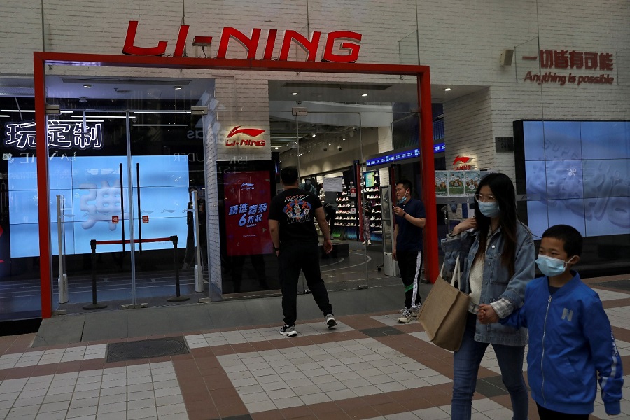 People walk past a Li Ning store in Beijing in April 2021. Photo by REUTERS
