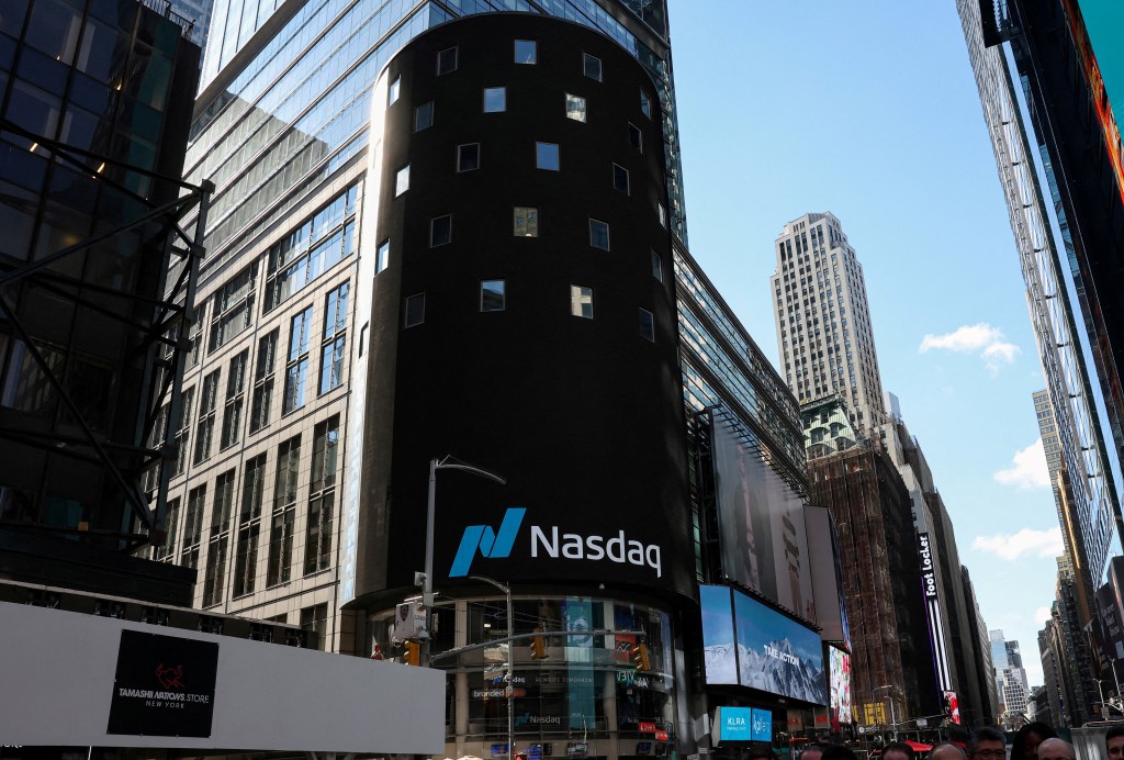 The Nasdaq logo is displayed on a screen at the Nasdaq Market site in Times Square in New York City, U.S., April 17, 2026. REUTERS/Brendan McDermid/File Photo