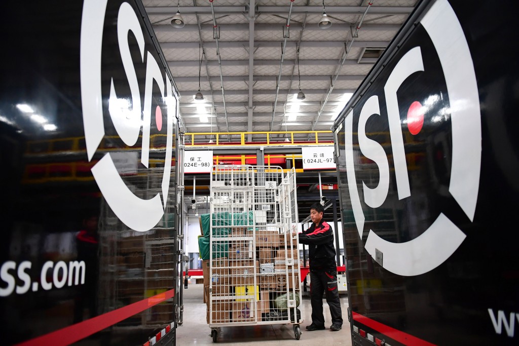 A worker moves parcels at an SF Express distribution centre ahead of the Singles Day online shopping festival, in Shenyang, Liaoning province, China October 24, 2018. Picture taken October 24, 2018. REUTERS/Stringer