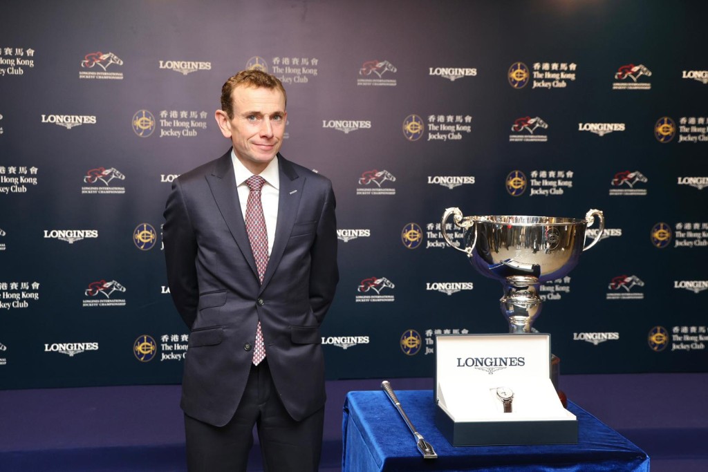 Ryan Moore stands with the IJC trophy after his two wins seized victory. Singtao