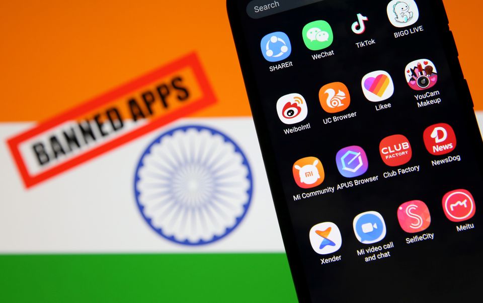 Smartphone with Chinese applications is seen in front of a displayed Indian flag. (Reuters) Smartphone with Chinese applications is seen in front of a displayed Indian flag. (Reuters)
