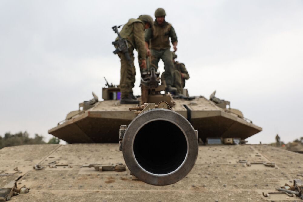 Israeli soldiers position their Merkava tank near the border with the Gaza Strip. AFP Israeli soldiers position their Merkava tank near the border with the Gaza Strip. AFP