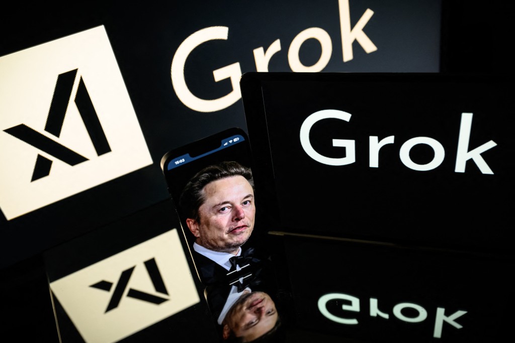 Photo by LIONEL BONAVENTURE / AFP  This photograph taken on January 13, 2025 in Toulouse shows screens displaying the logo of Grok, a generative artificial intelligence chatbot developed by xAI, the American company specializing in artificial intelligence and it's founder South African businessman Elon Musk.
