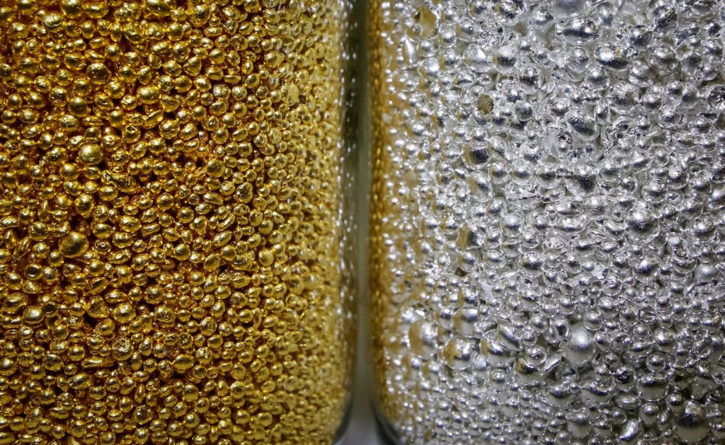 Granules of 99.99 percent pure gold and silver are seen in glass jars at the Krastsvetmet non-ferrous metals plant, one of the world's largest producers in the precious metals industry, in the Siberian city of Krasnoyarsk, Russia November 22, 2018. Picture taken November 22, 2018. REUTERS