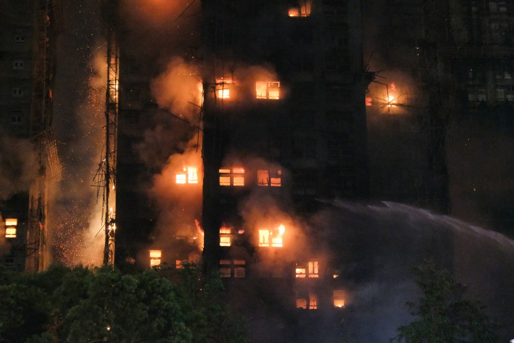 Photo by TOMMY WANG / AFP  Flames rise as a major fire engulfs several apartment blocks at the Wang Fuk Court residential estate in Hong Kong's Tai Po district on November 26, 2025.
