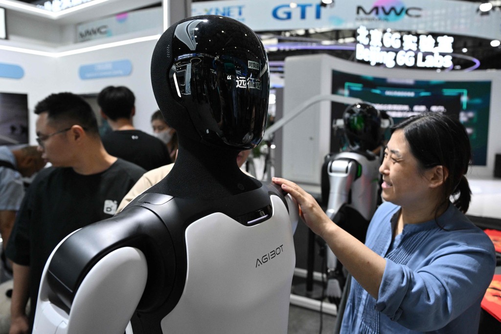 A humanoid robot is seen at the Agibot booth during the Mobile World Congress (MWC) in Shanghai on June 24, 2026. (Photo by HECTOR RETAMAL / AFP)