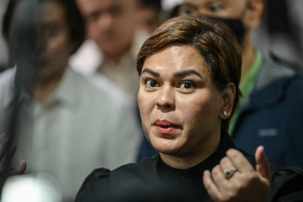 Photo by TED ALJIBE / AFP  Philippine Vice President Sara Duterte talks to members of the media after posting bail at a court building in Quezon City suburban Manila on September 5, 2026.