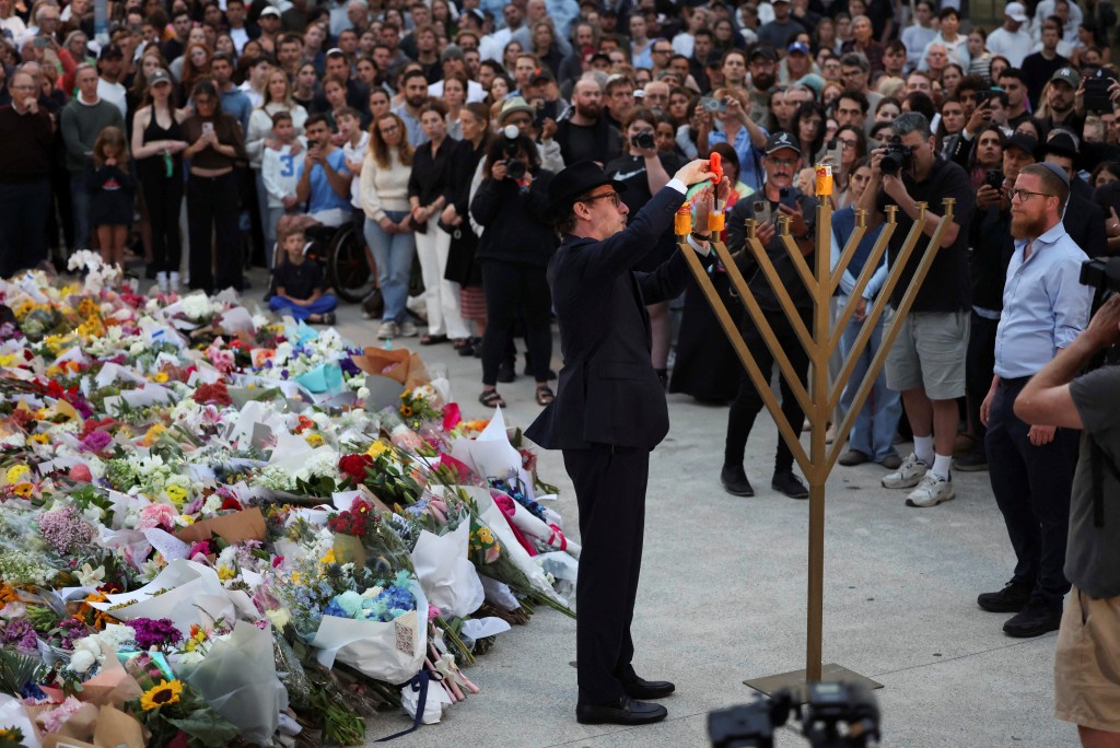 Rabbi Levi Wolff lights a menorah at Bondi Pavilion to honour the victims of a shooting during a Jewish holiday celebration at Bondi Beach, in Sydney, Australia, December 15, 2025. REUTERS/Hollie Adams