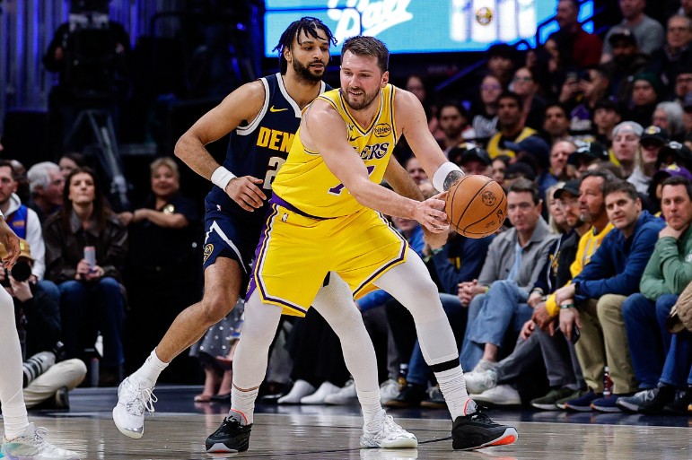 Luka Doncic controls the ball under pressure from Denver Nuggets guard Jamal Murray. REUTERS 