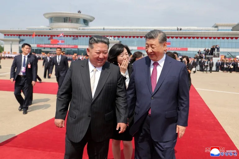 North Korean leader Kim Jong Un, left, walks with Chinese leader Xi Jinping during Xi's state visit to Pyongyang, North Korea, on June 9, 2026 [KCNA via Reuters]