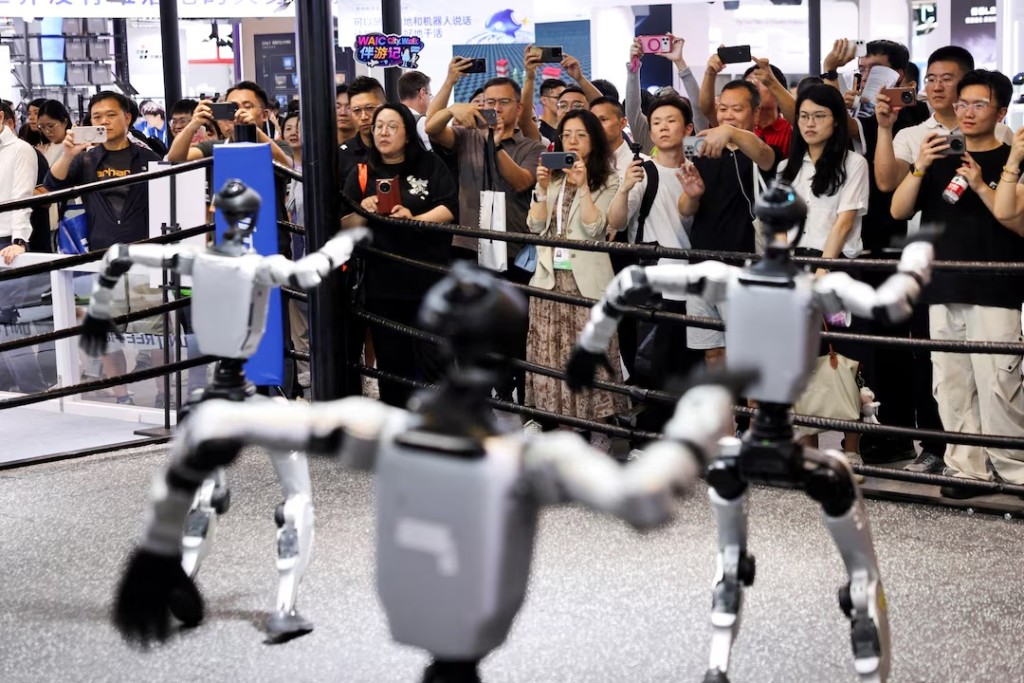 People watch humanoid robots dance at the Unitree booth during the World Artificial Intelligence Conference (WAIC) in Shanghai, China, July 17, 2026. REUTERS/Go Nakamura/File Photo